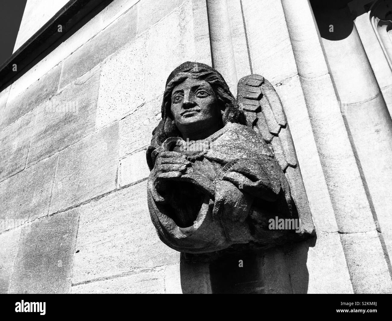 Angel gargoyle outside Magdalen college Stock Photo
