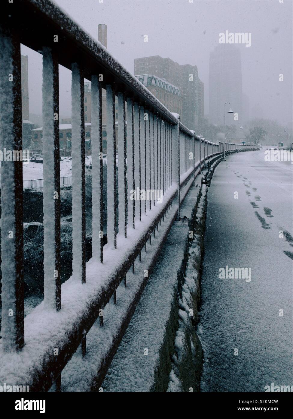 Walking down a bridge during an April snow storm in Minneapolis. Stock Photo