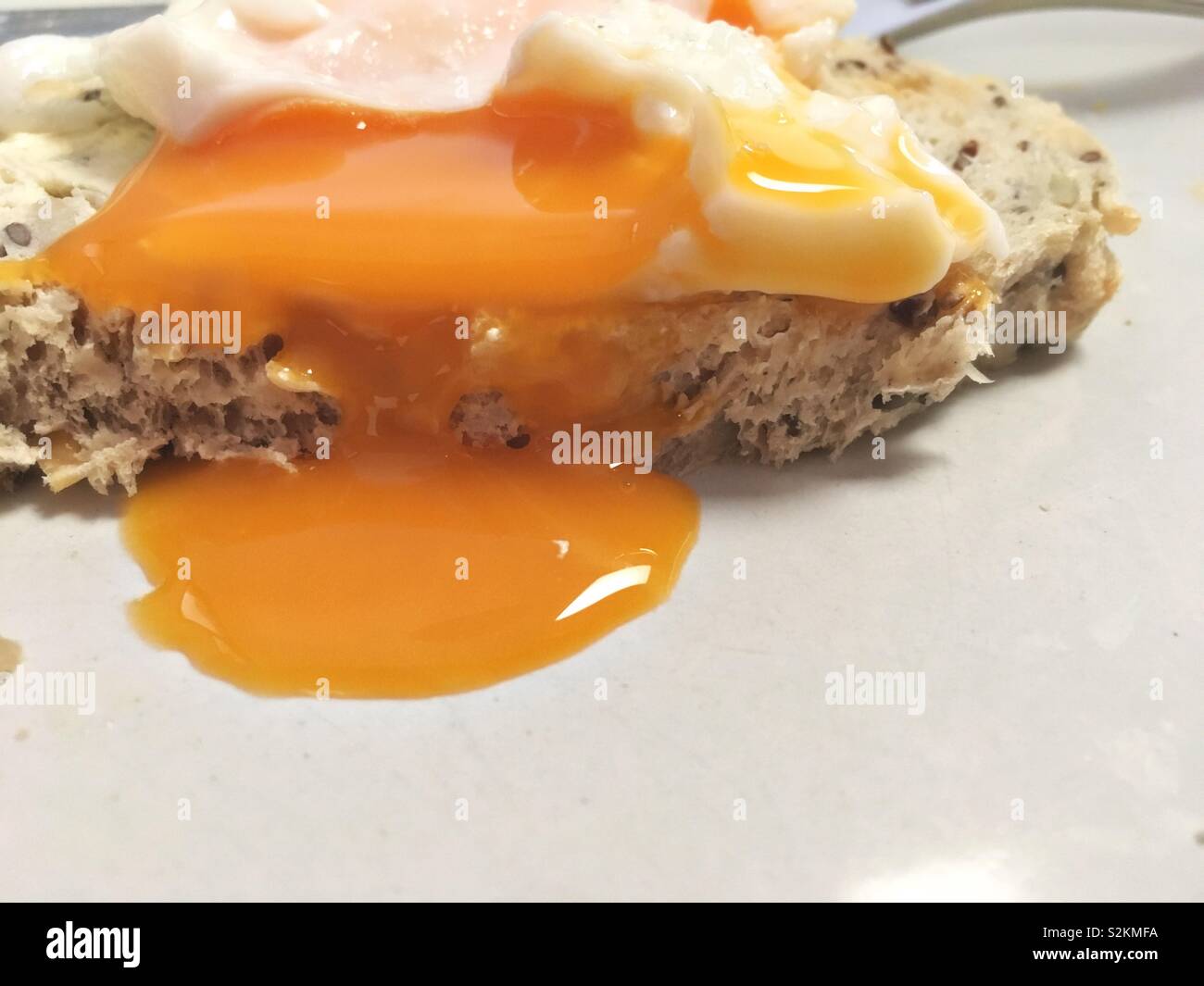 Poached free range egg on a superfood gluten free grain bread.  Delicious protein snack. Stock Photo