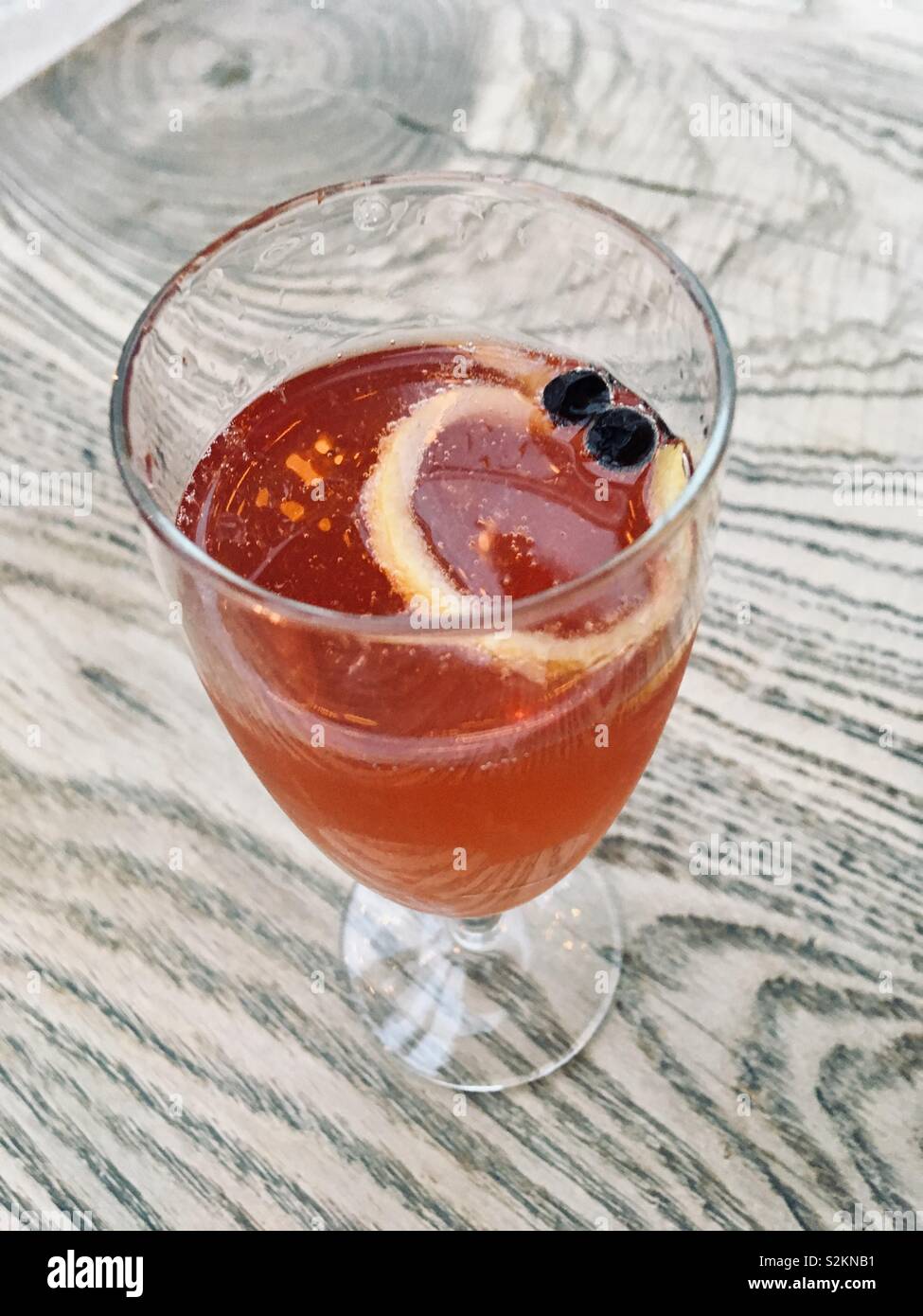Prosecco cocktail with blackberry liquor in a champagne flute - Smartphone Captured Stock Image