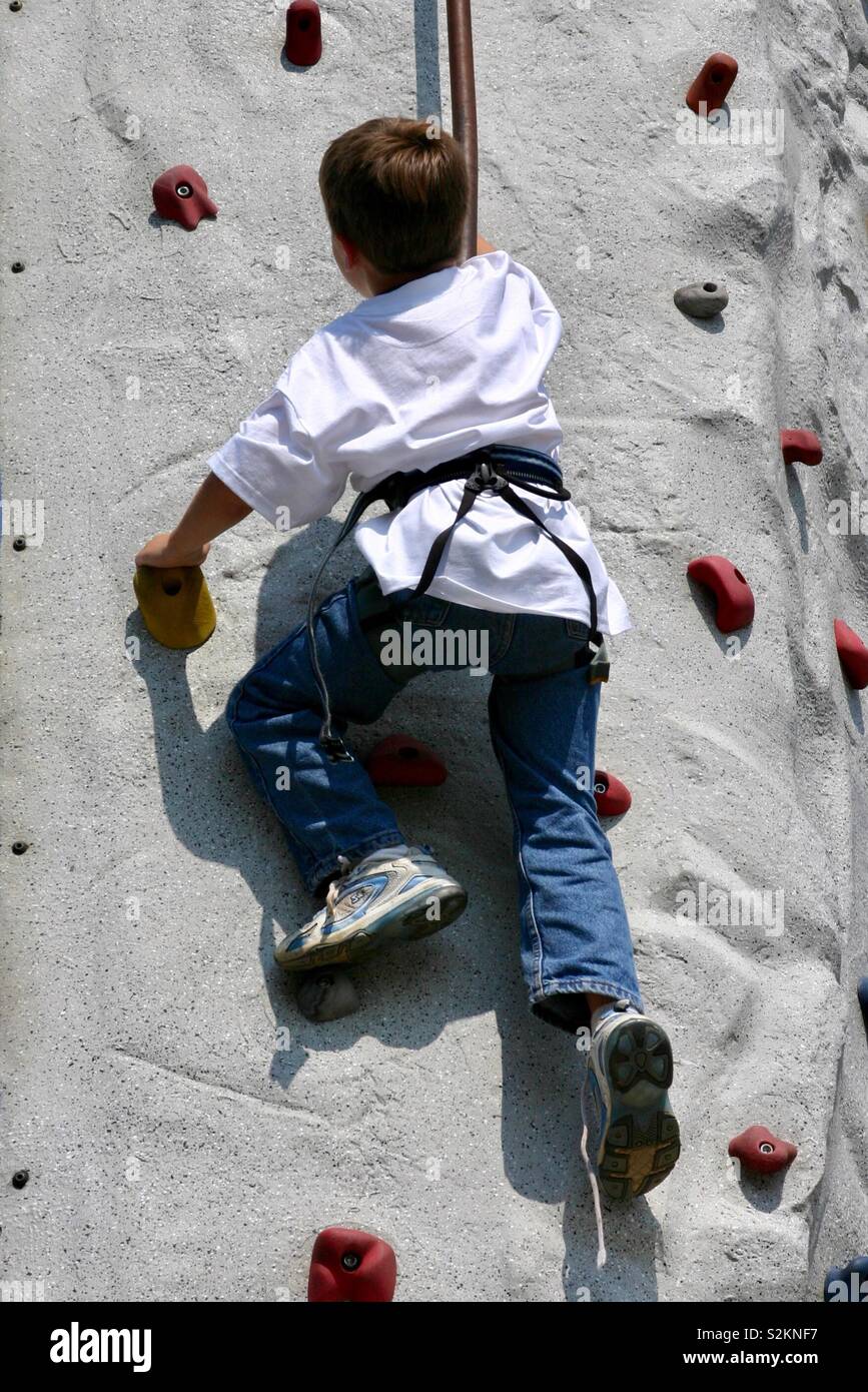 Boy scales plastic rock climbing wall. Taken in Biloxi, MS on June 17