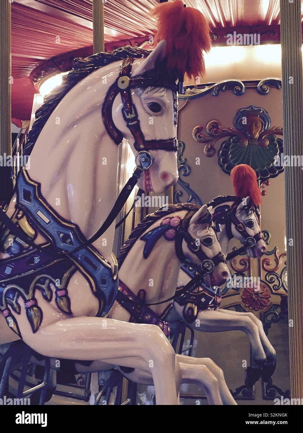 Horses to enjoy a funny trip in a carrousel Stock Photo