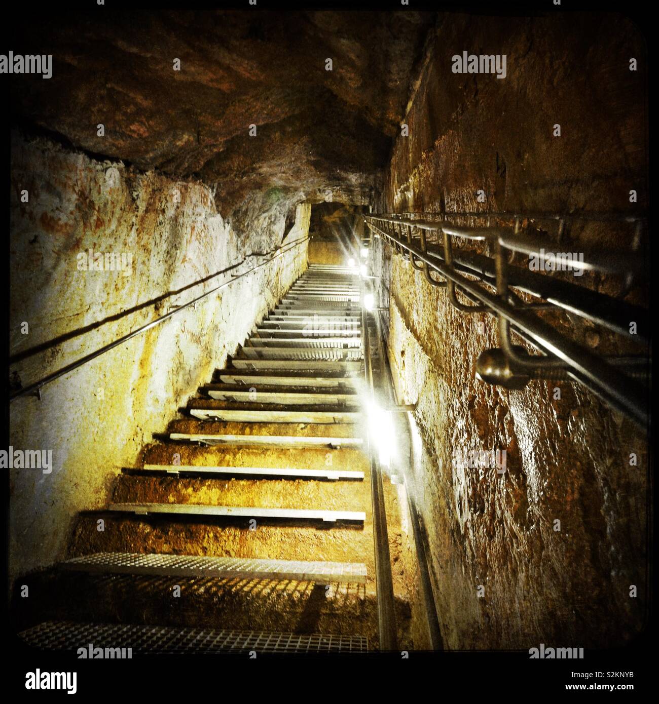Underground industrial steps cut through rock Stock Photo