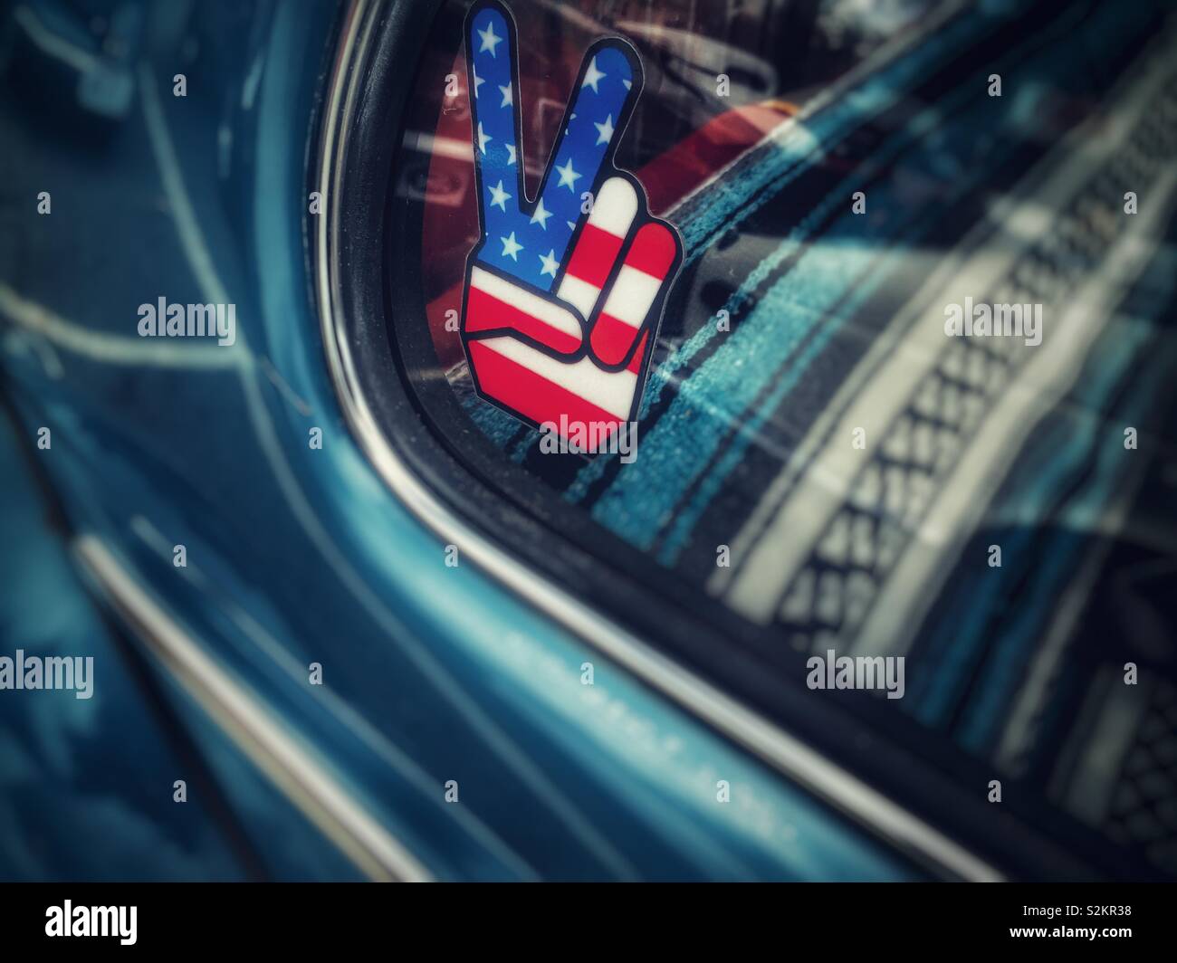 Patriotic peace symbol sticker on the window of a vintage Volkswagen Beetle Stock Photo