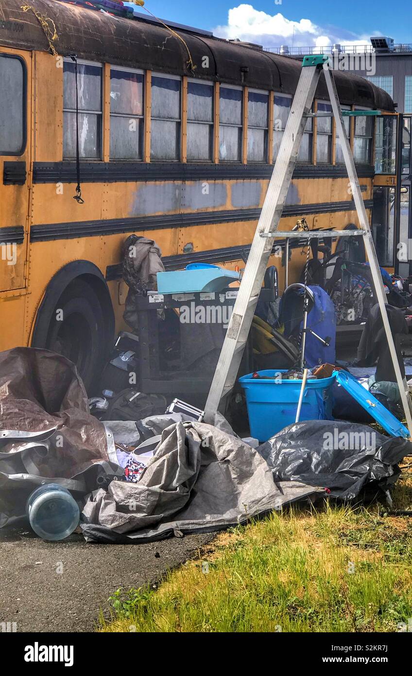 Abandoned bus with junk from homeless people Stock Photo