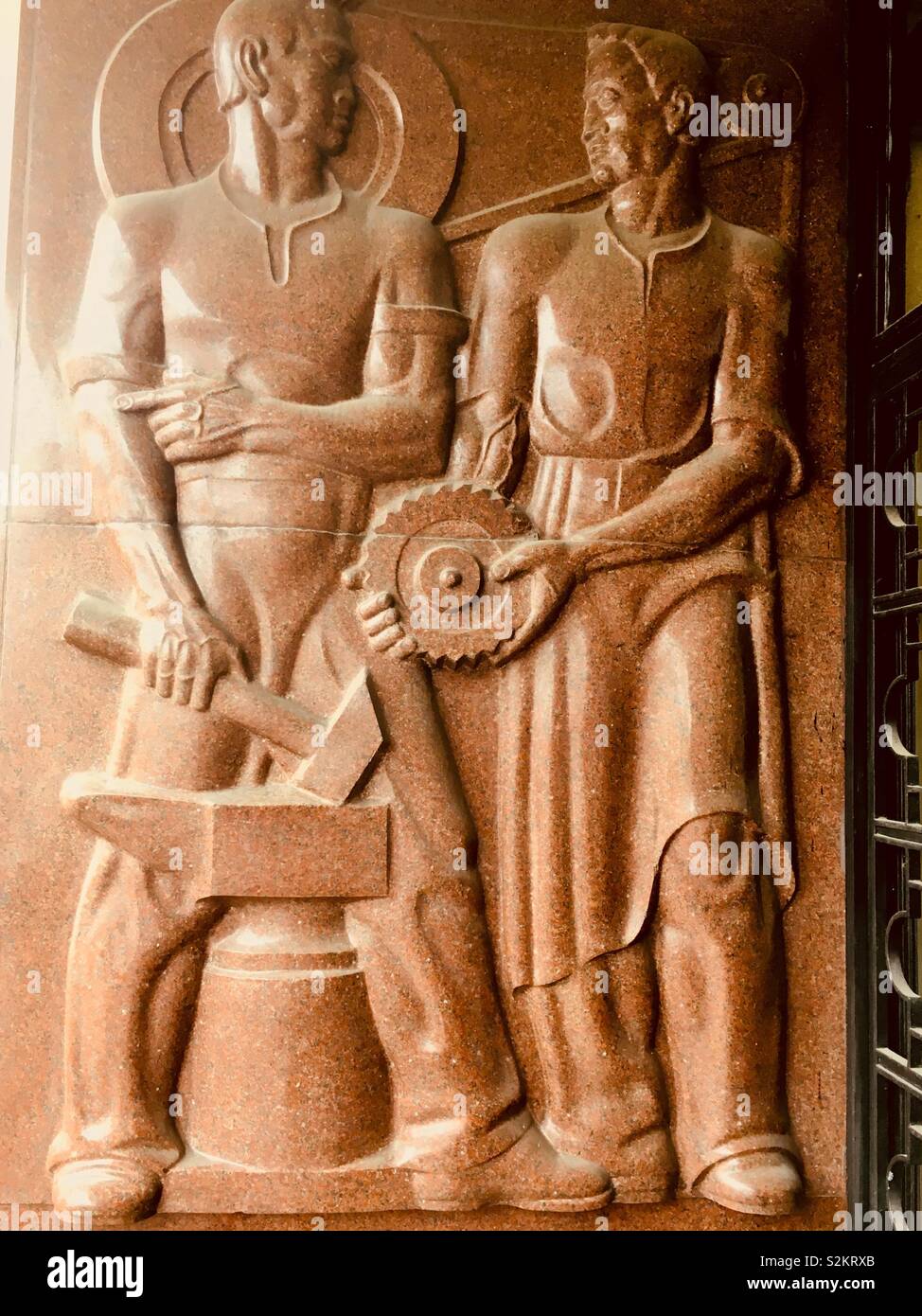 ‘Industry’ relief by Jozef Below, ca 1936, Warsaw, Poland - Smartphone Captured Stock Image