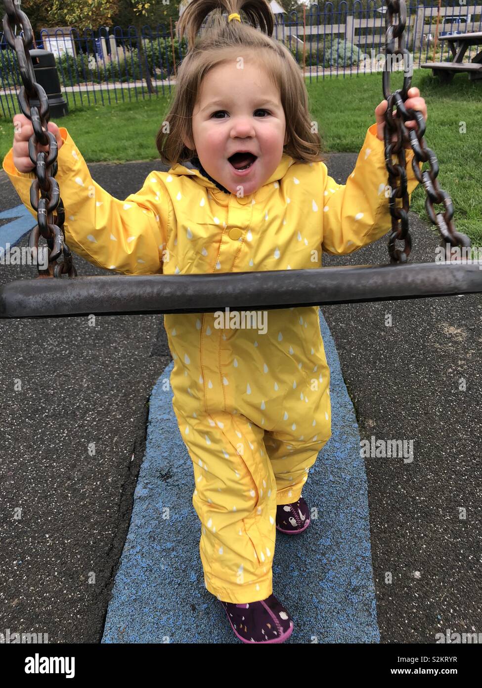 Playing child with swing Stock Photo - Alamy
