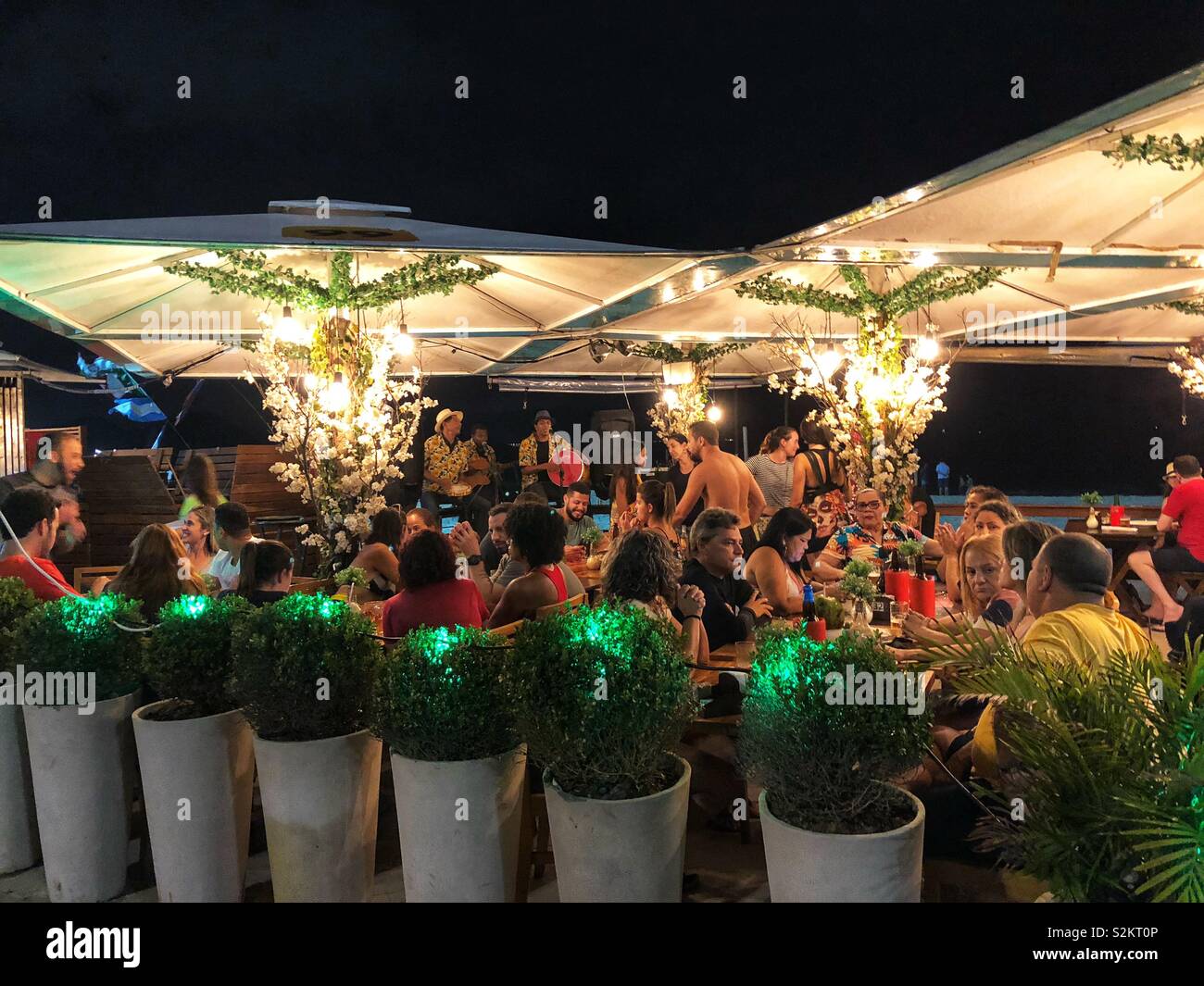 Outdoor entertainment on Copacabana beach at night, Rio de Janeiro, Brazil. - Smartphone Captured Stock Image