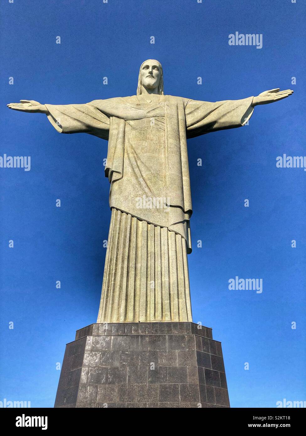 The iconic Christ the Redeemer statue in Corcovado, Rio de Janeiro, Brazil, on a clear blue day. - Smartphone Captured Stock Image