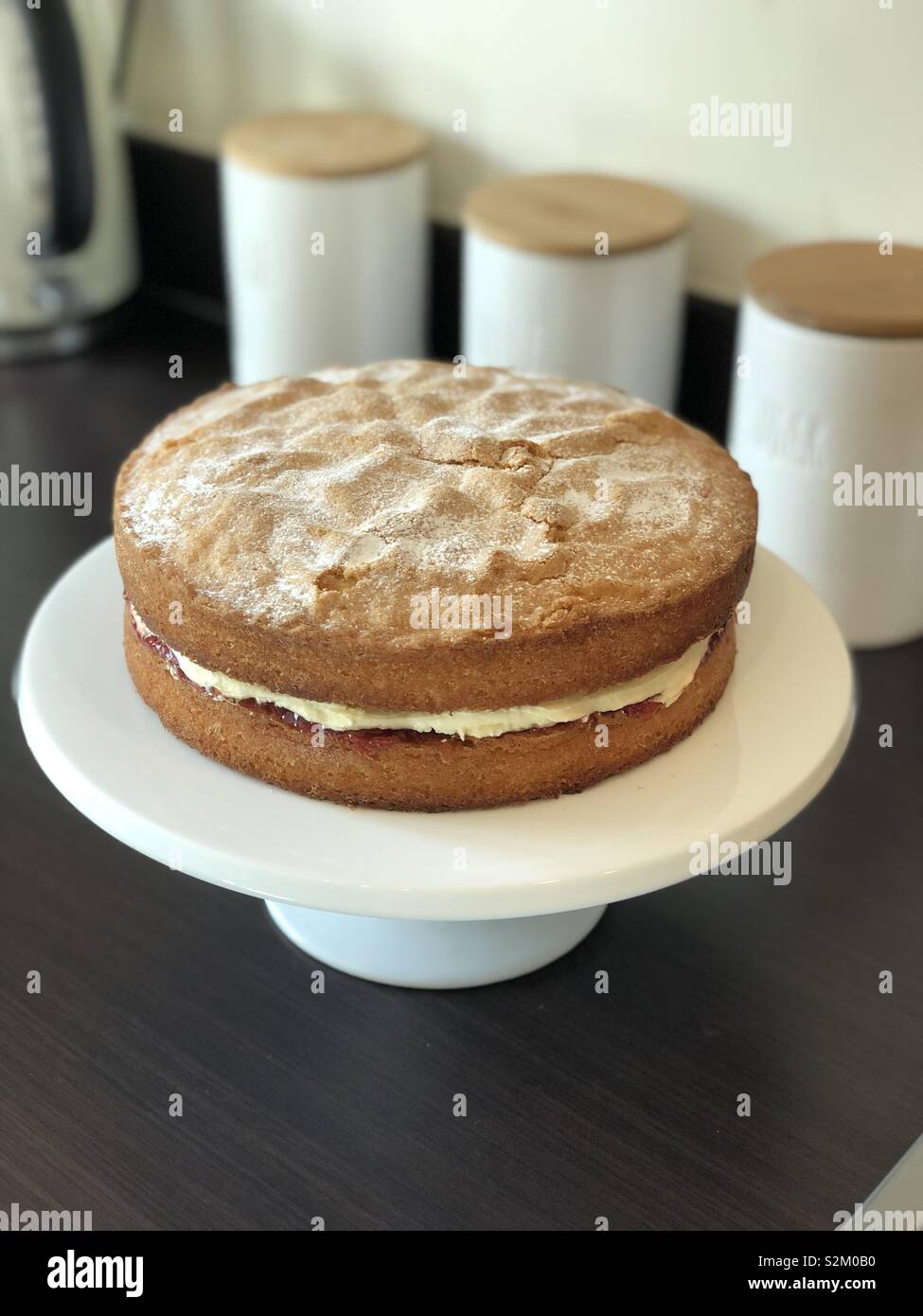 Victoria sponge cake on stand home baked Stock Photo