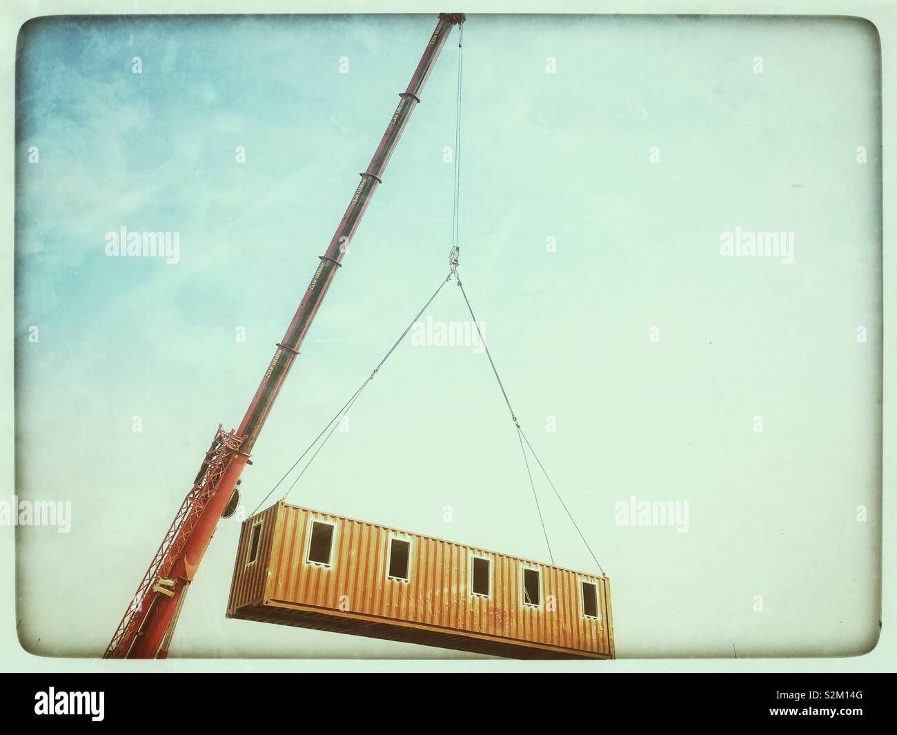 Prefabricated building moved by crane - Smartphone Captured Stock Image