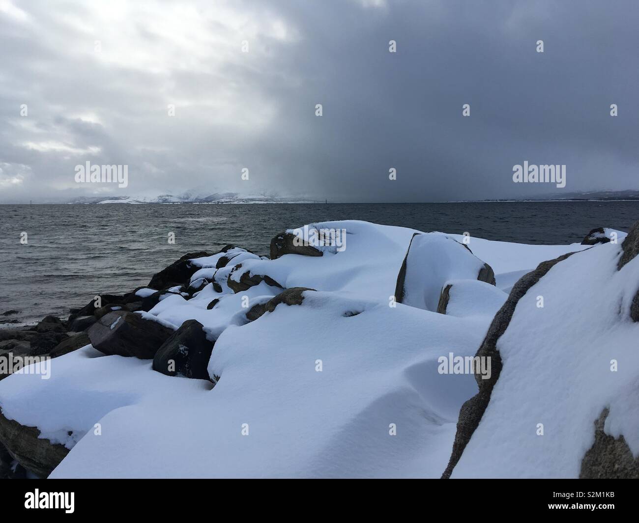 Snowed covered rocks Stock Photo - Alamy