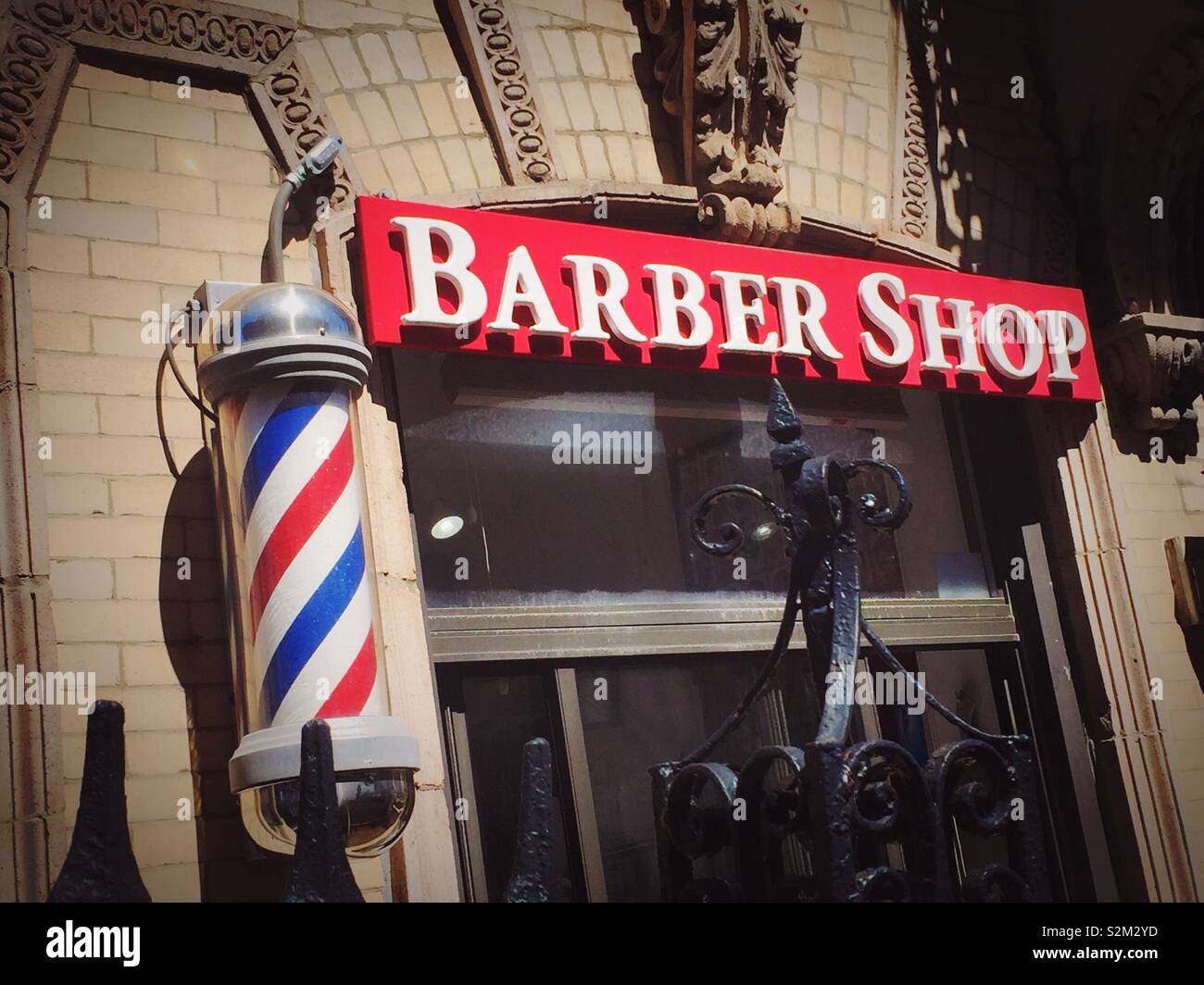 Barber shop storefront and striped Barber Pole, NYC, USA Stock Photo