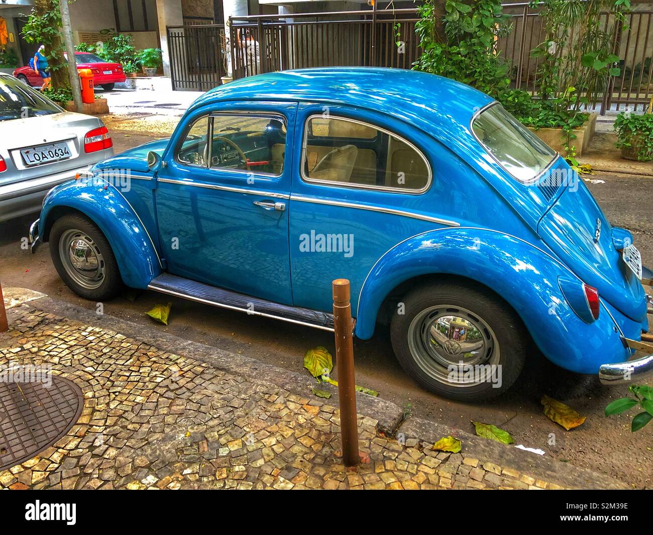 A well preserved blue vintage iconic VW beetle parked on a street in ...