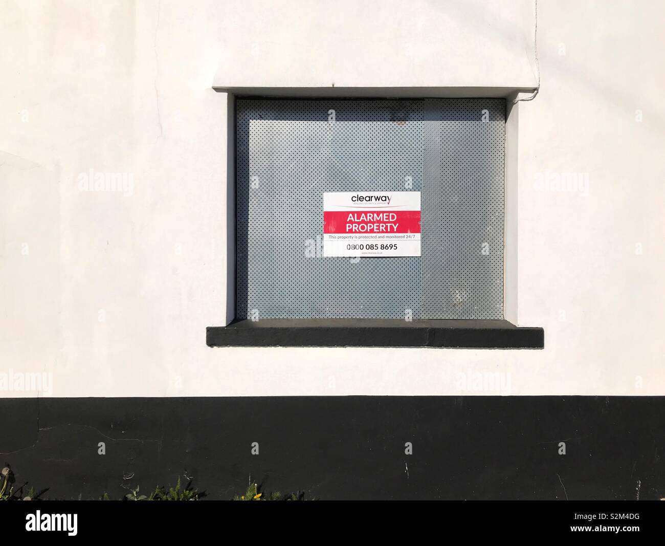 Boarded up window with security notice on a public house which has closed down - Smartphone Captured Stock Image