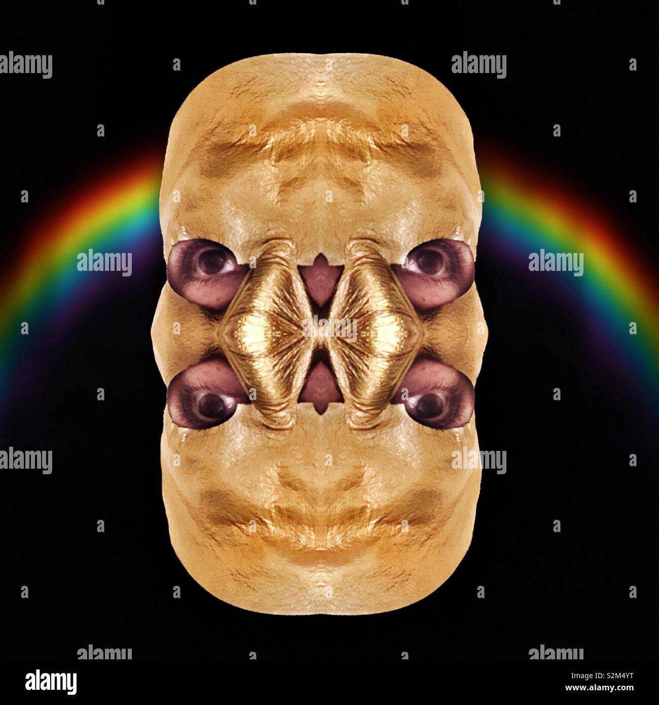 An abstract digital artwork of a head with four eyes and two noses covered in gold foil against a rainbow Stock Photo