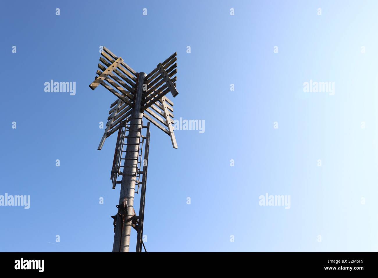 Abstract image of marker post at end of stone jetty Stock Photo