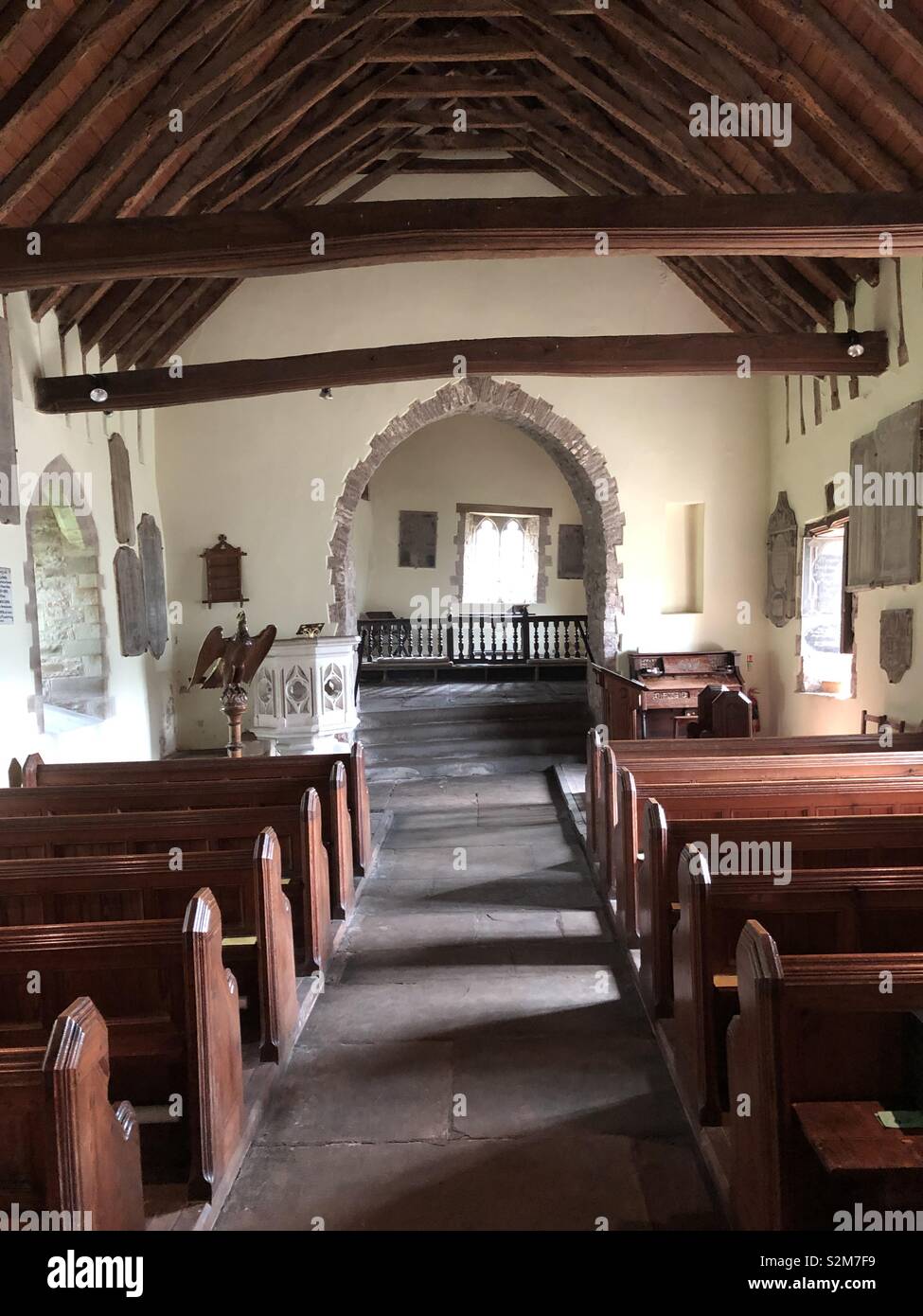 Unusual view of the completely crooked interior of Cwmyoy Church in the Black Mountains in Wales. There is not a single straight wall. - Smartphone Captured Stock Image