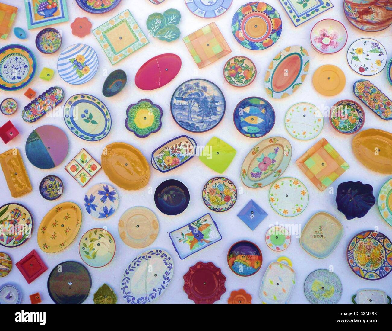 Colorful ceramic plates secured to a wall outside a shop in Portugal