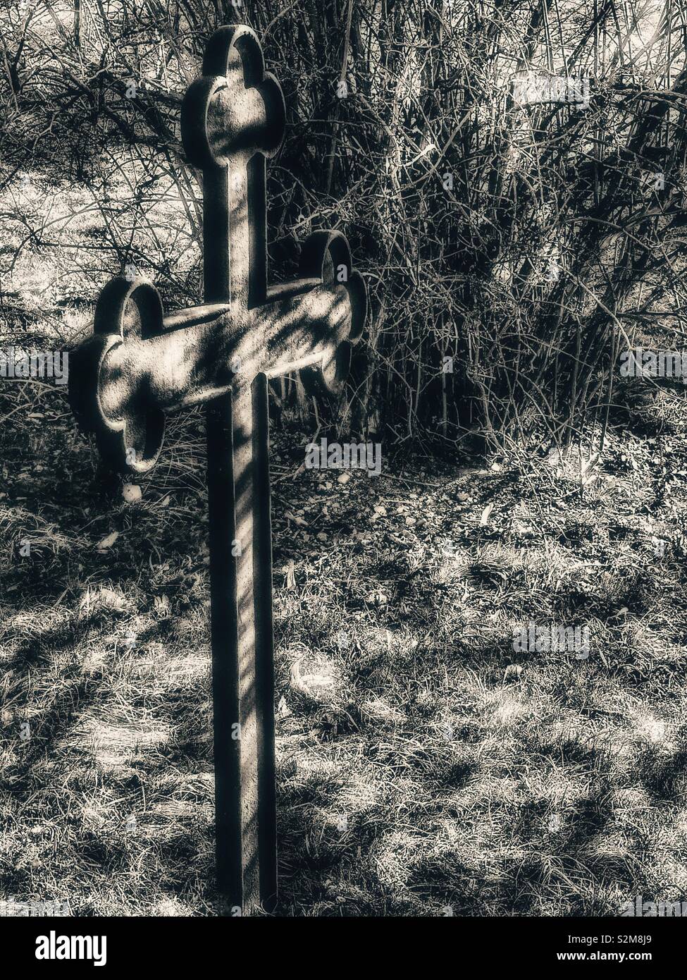 Atmospheric black and white cross with sunlight and shadow, Sweden, Scandinavia - Smartphone Captured Stock Image