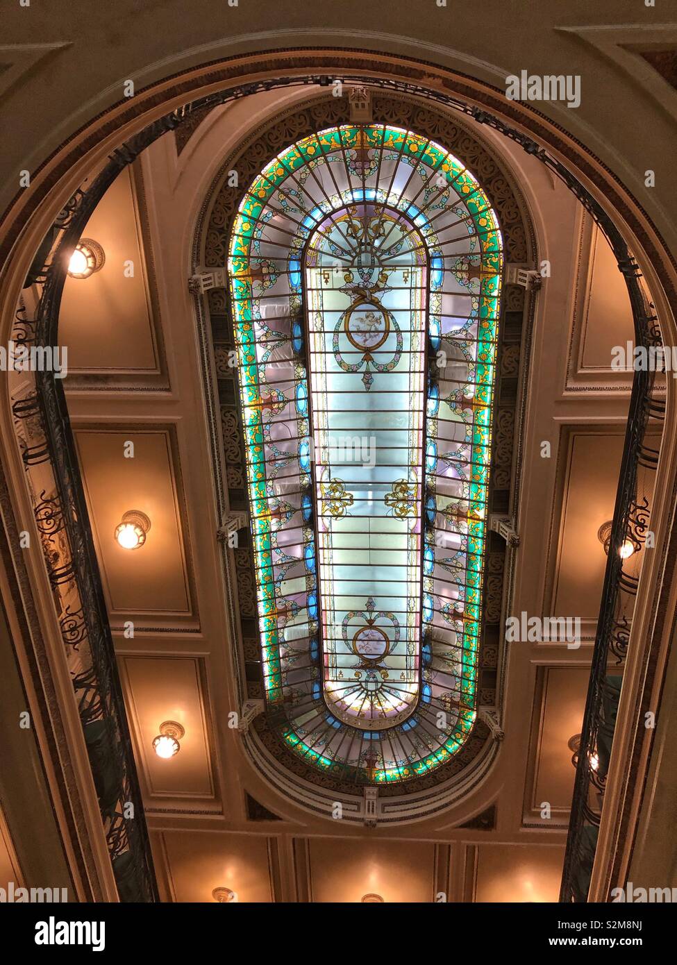 The elegant stained glass ceiling in the iconic Café Colombo in downtown Rio de Janeiro, Brazil. - Smartphone Captured Stock Image