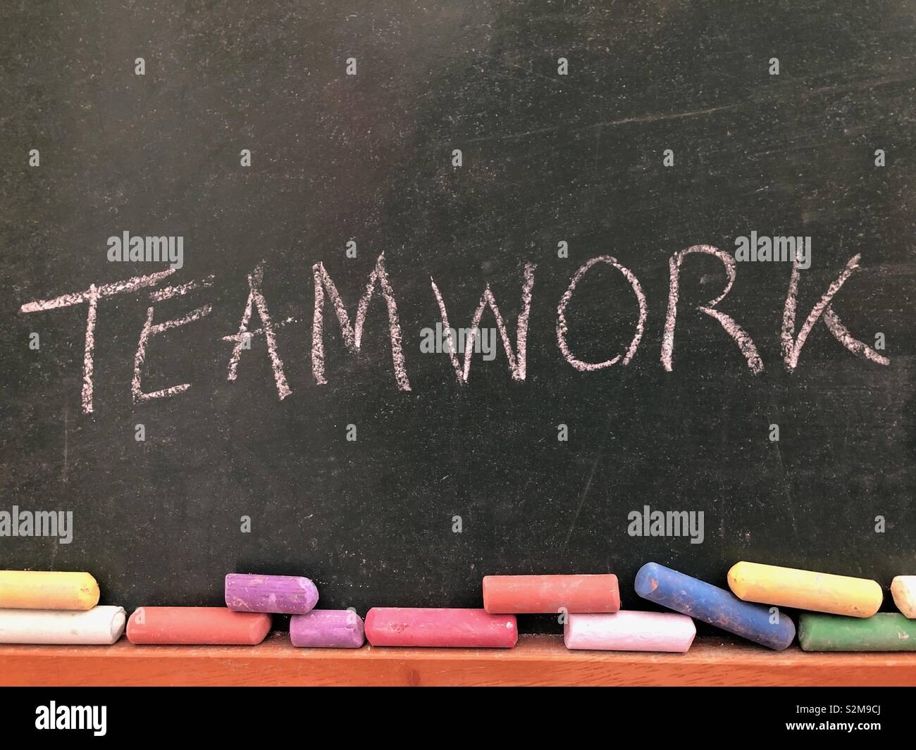 Teamwork written on a chalkboard Stock Photo