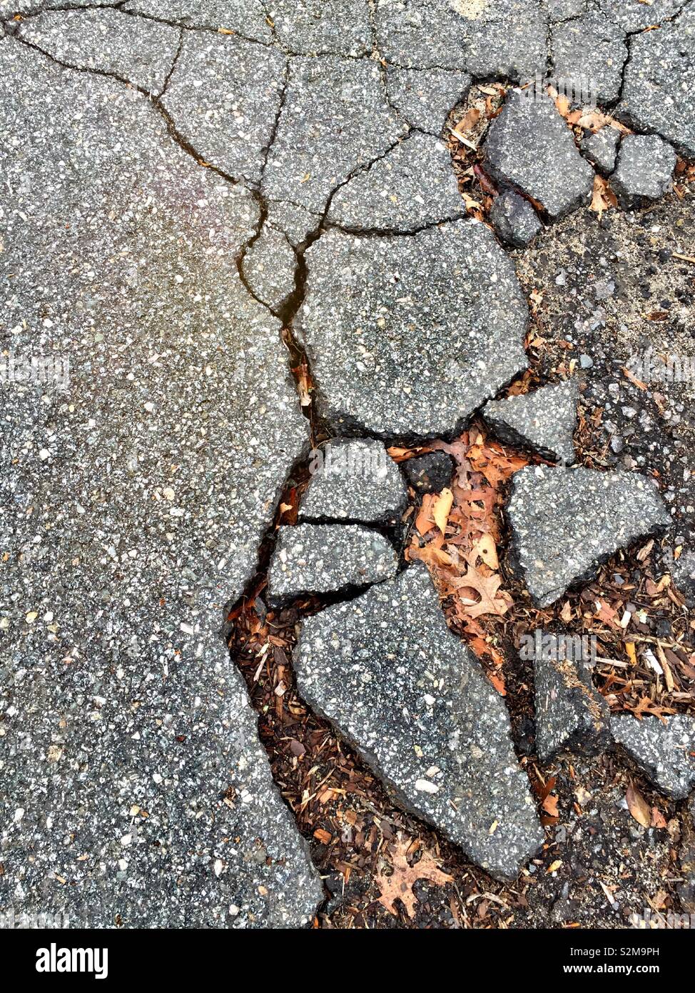 Close up of cracked and broken pavement shop from above, USA - Smartphone Captured Stock Image