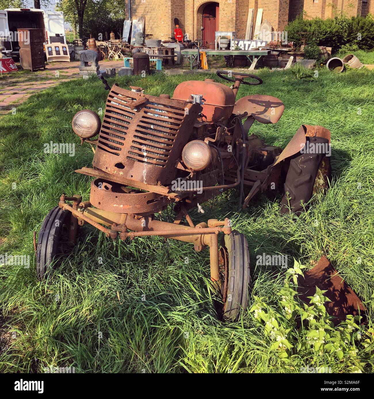 Clapped out old tractor outside a Belgian brocante Stock Photo