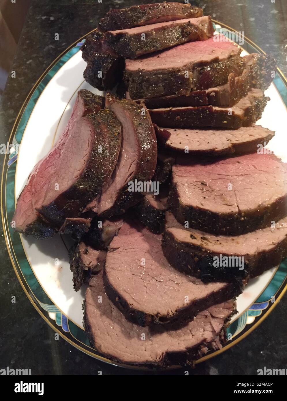 Close up of a platter of sliced beef tenderloin roast, USA - Smartphone Captured Stock Image