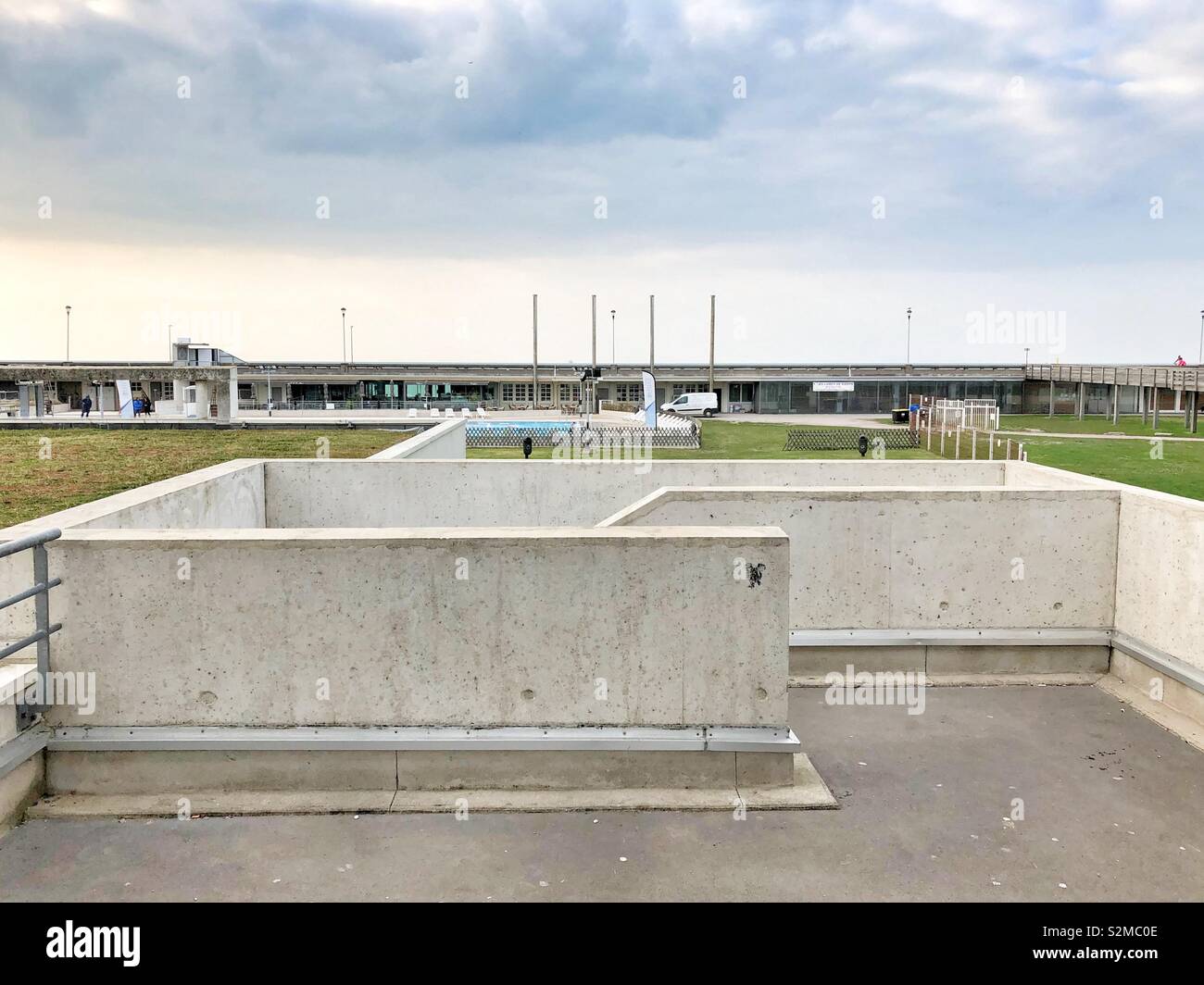 View to the Dieppe aquatic centre on the waterfront with concrete stairway in the foreground. Stock Photo