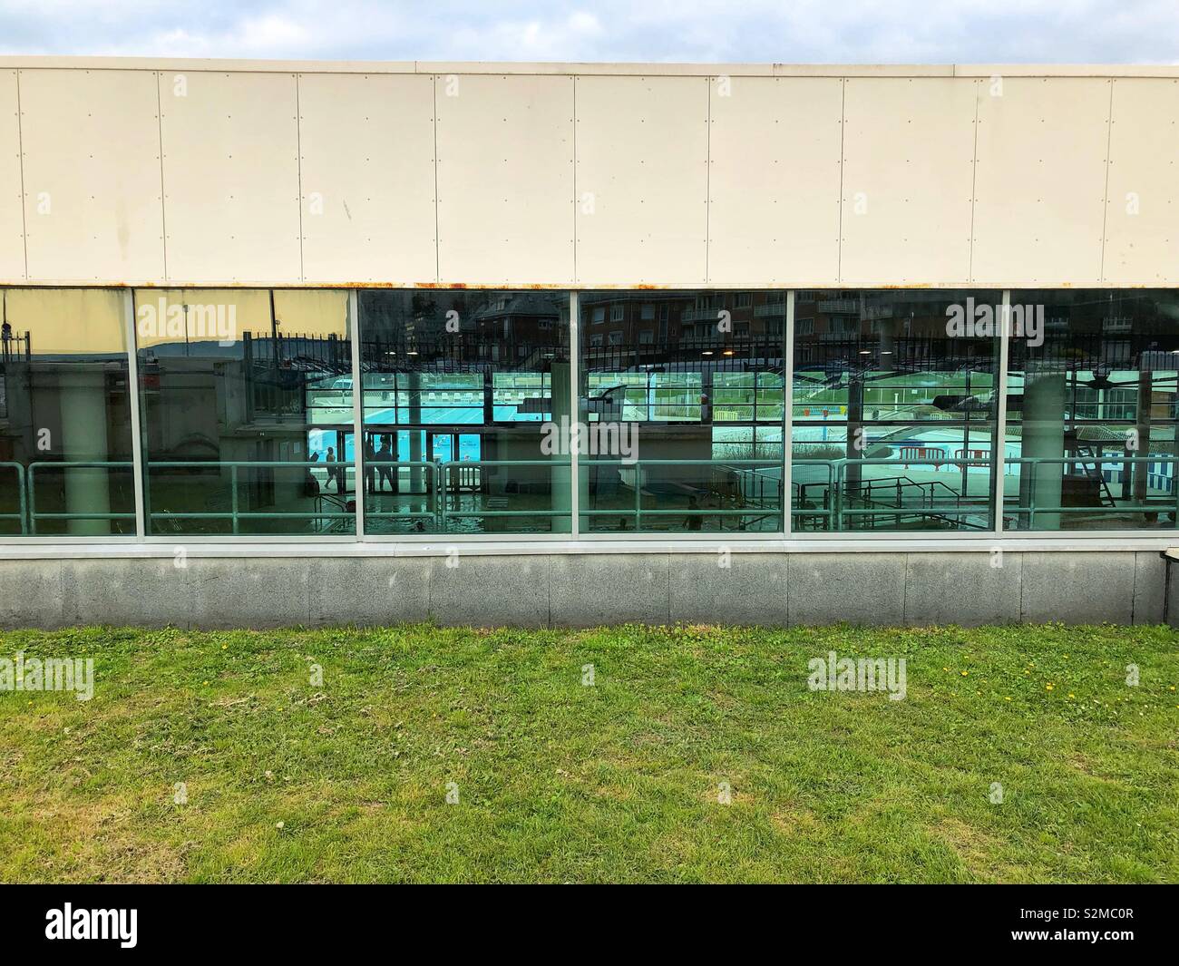 A section of the Dieppe aquatic centre and spa with the swimming pool visible through the windows. Stock Photo