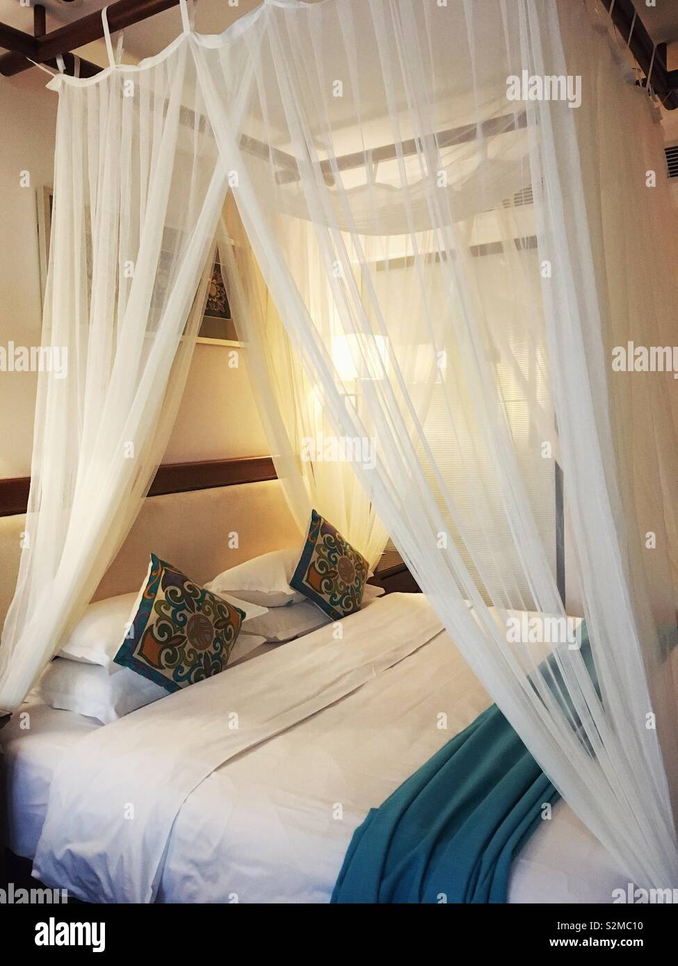 A bed with drapes. - Smartphone Captured Stock Image