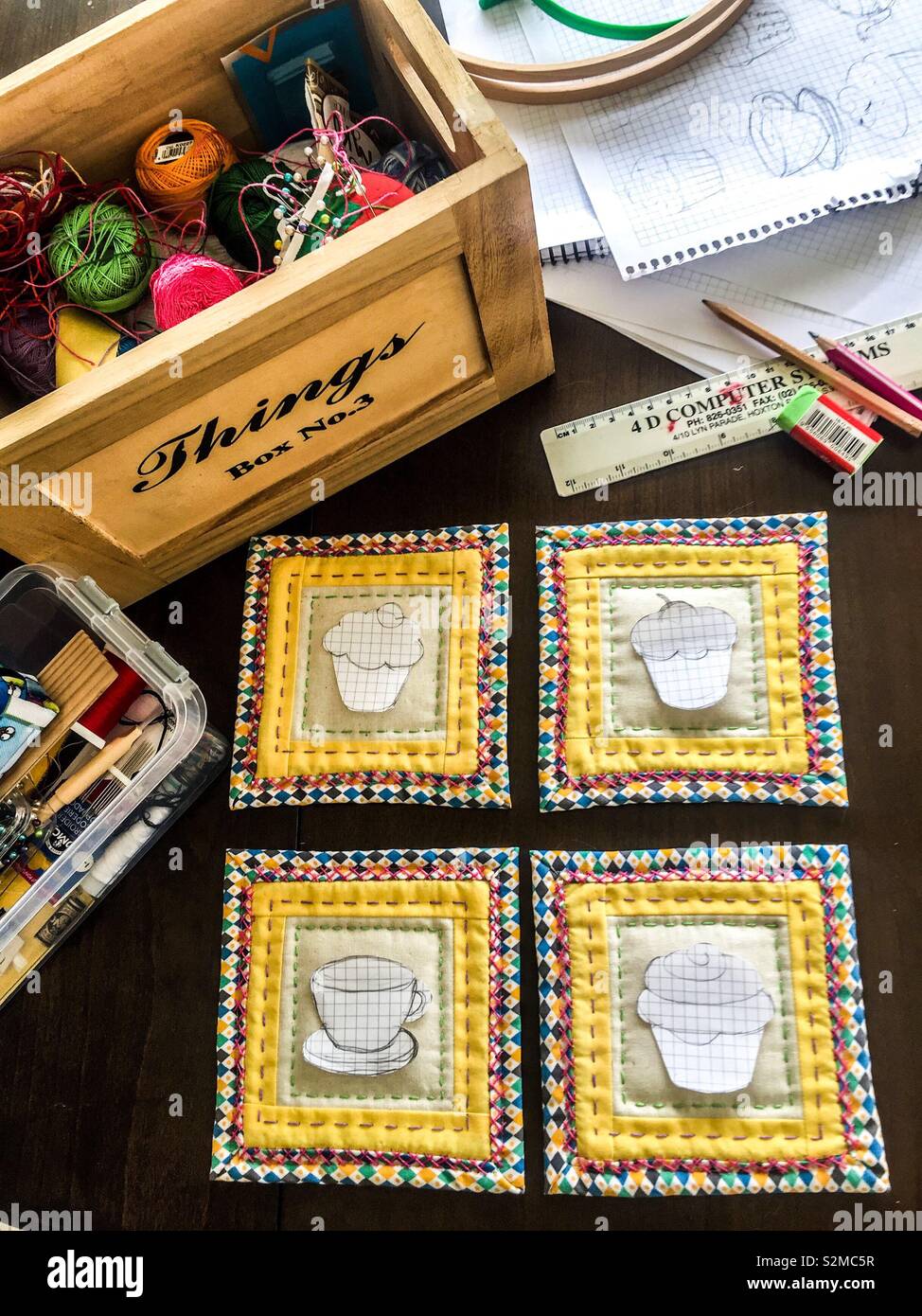 Patchwork hot pads. Transferring  embroidery patterns onto fabric - Smartphone Captured Stock Image