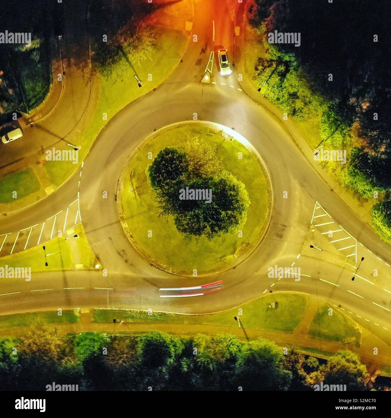Top down image of a roundabout at night from a drone with light trails - Smartphone Captured Stock Image