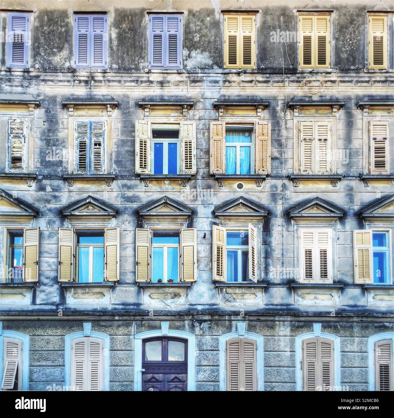 Facade of an old building, rows of windows - Monfalcone, Friuli Venezia Giulia, Italy - Smartphone Captured Stock Image