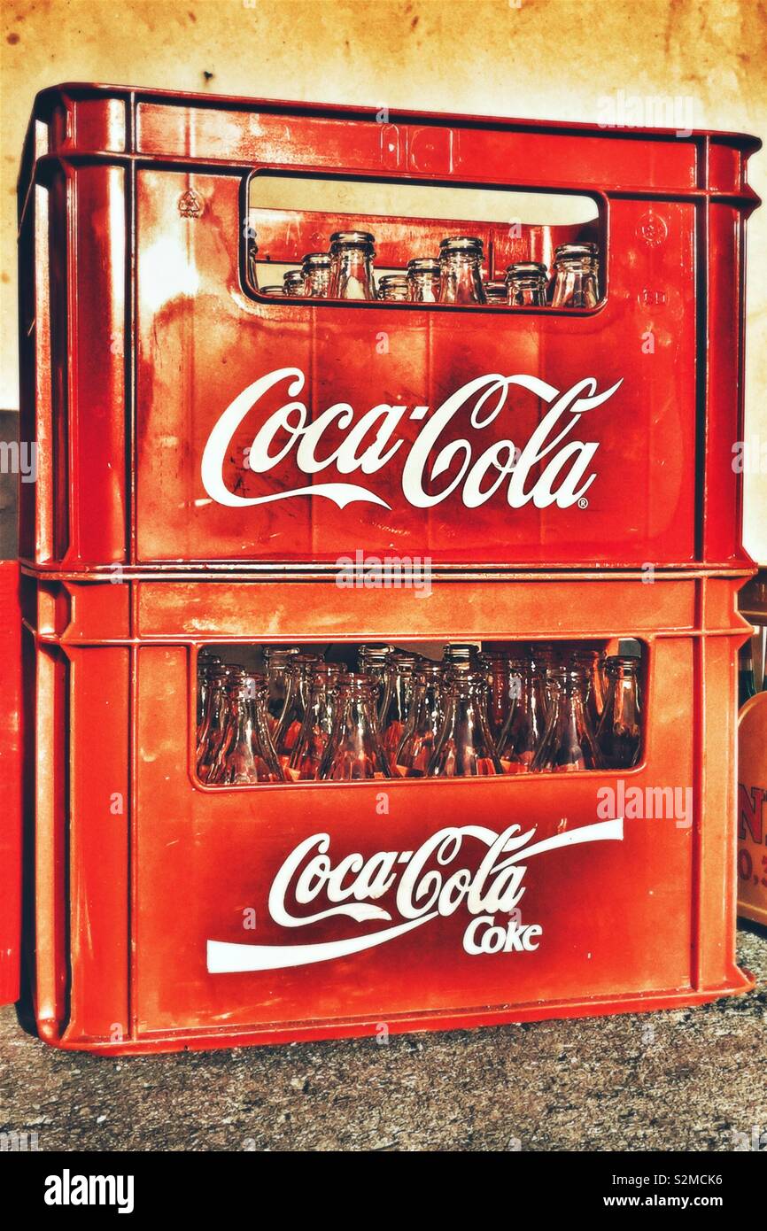 Stack of Coca Cola crates with empty Coca Cola bottles Stock Photo