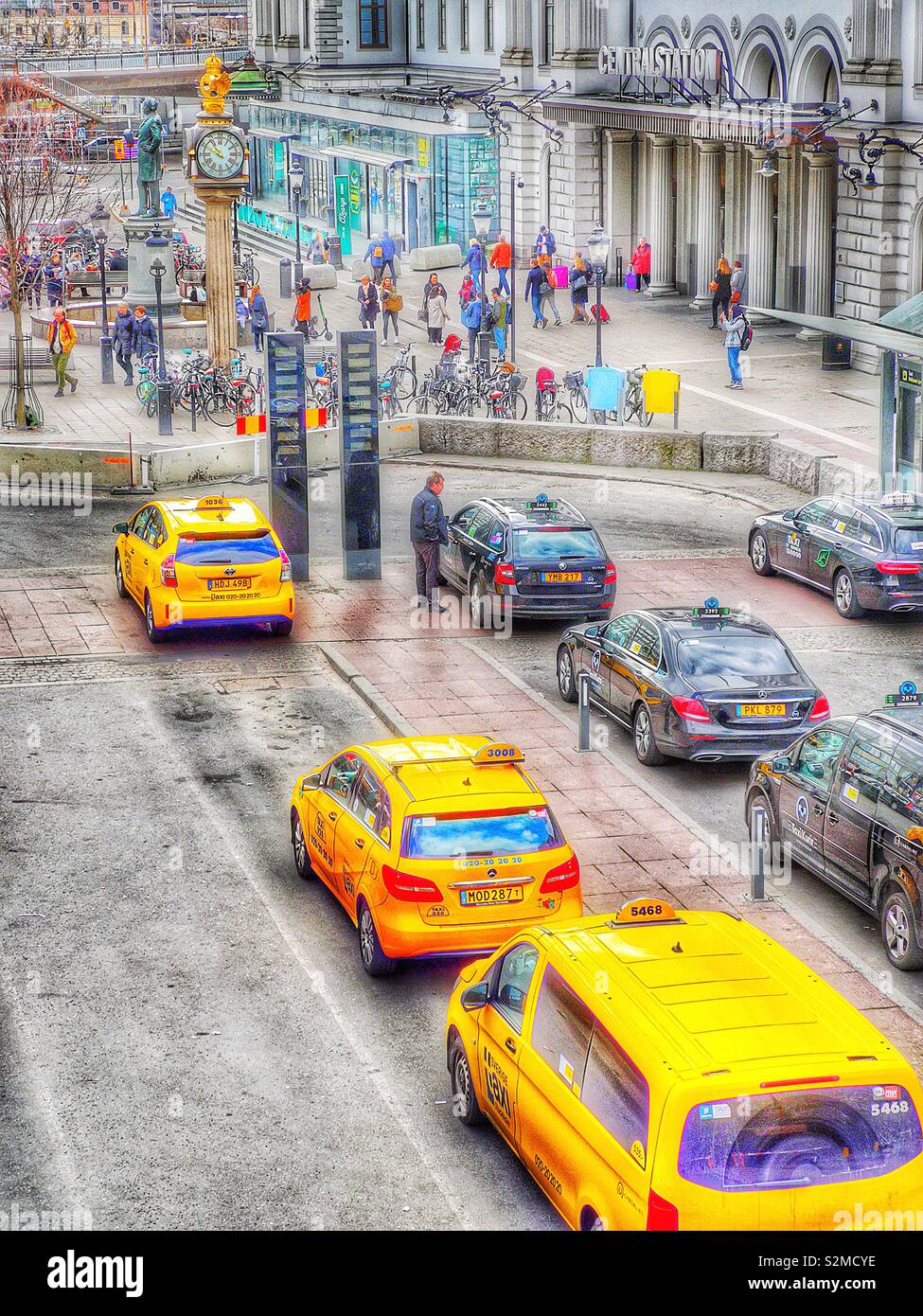 Yellow taxis queuing outside Stockholm Central Station, Stockholm, Sweden, Scandinavia - Smartphone Captured Stock Image