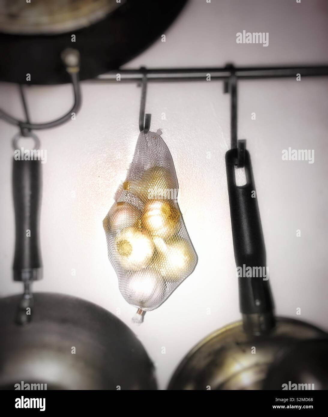 Garlic hanging from a kitchen hook - Smartphone Captured Stock Image