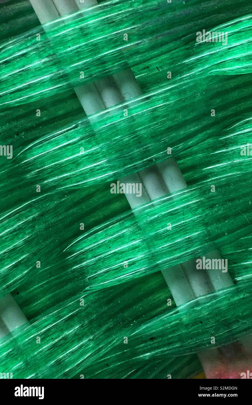 Green plastic basket weave pattern. - Smartphone Captured Stock Image