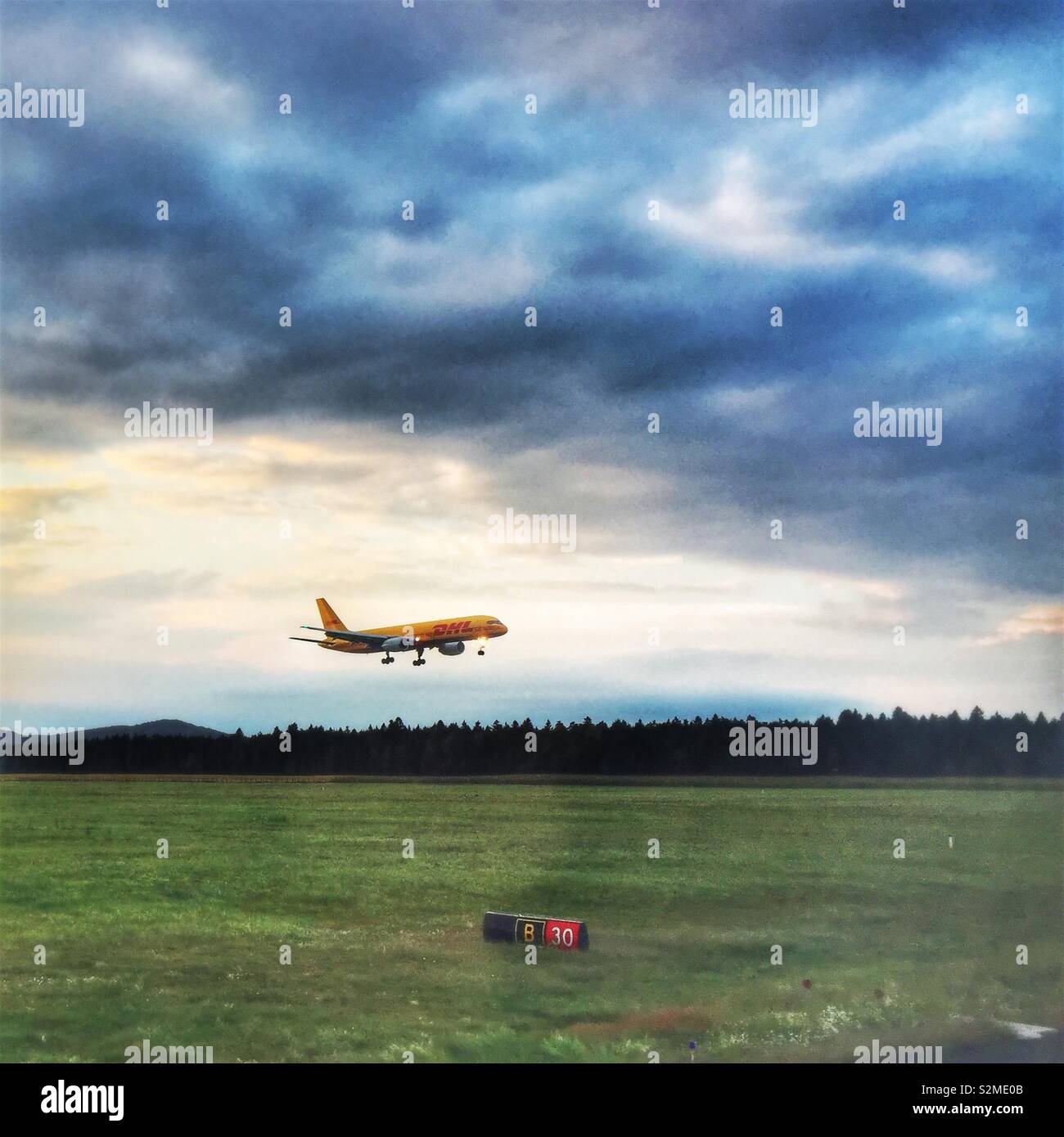 DHL airplane taking off from Ljubljana Airport- Brnik, Slovenia - Smartphone Captured Stock Image