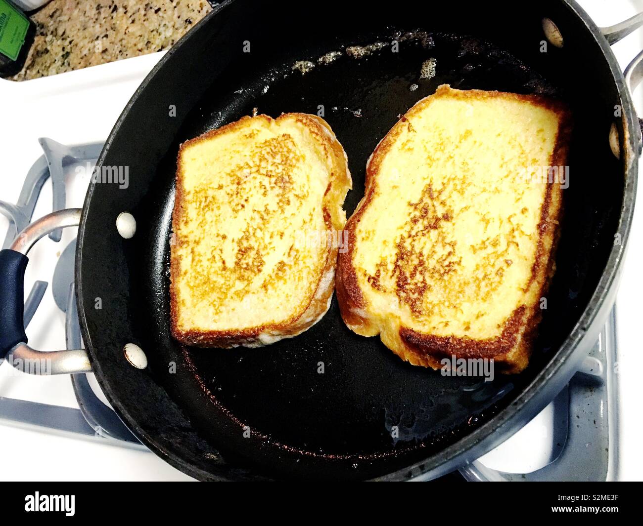 French toast cooking in cast iron frying pan Stock Photo Alamy