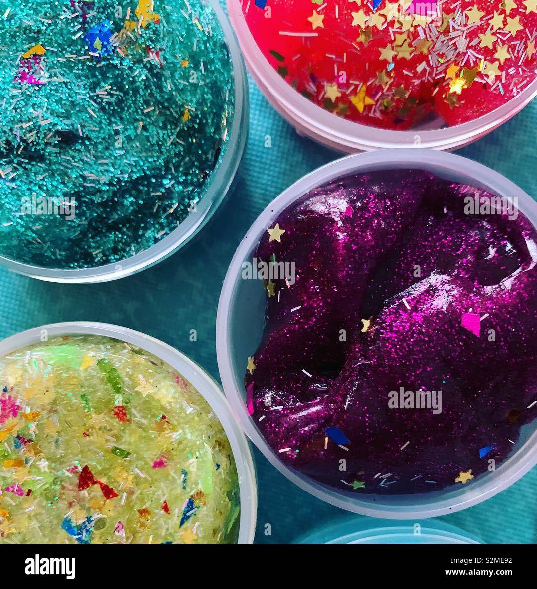 Colorful containers of kids’ slime Stock Photo - Alamy