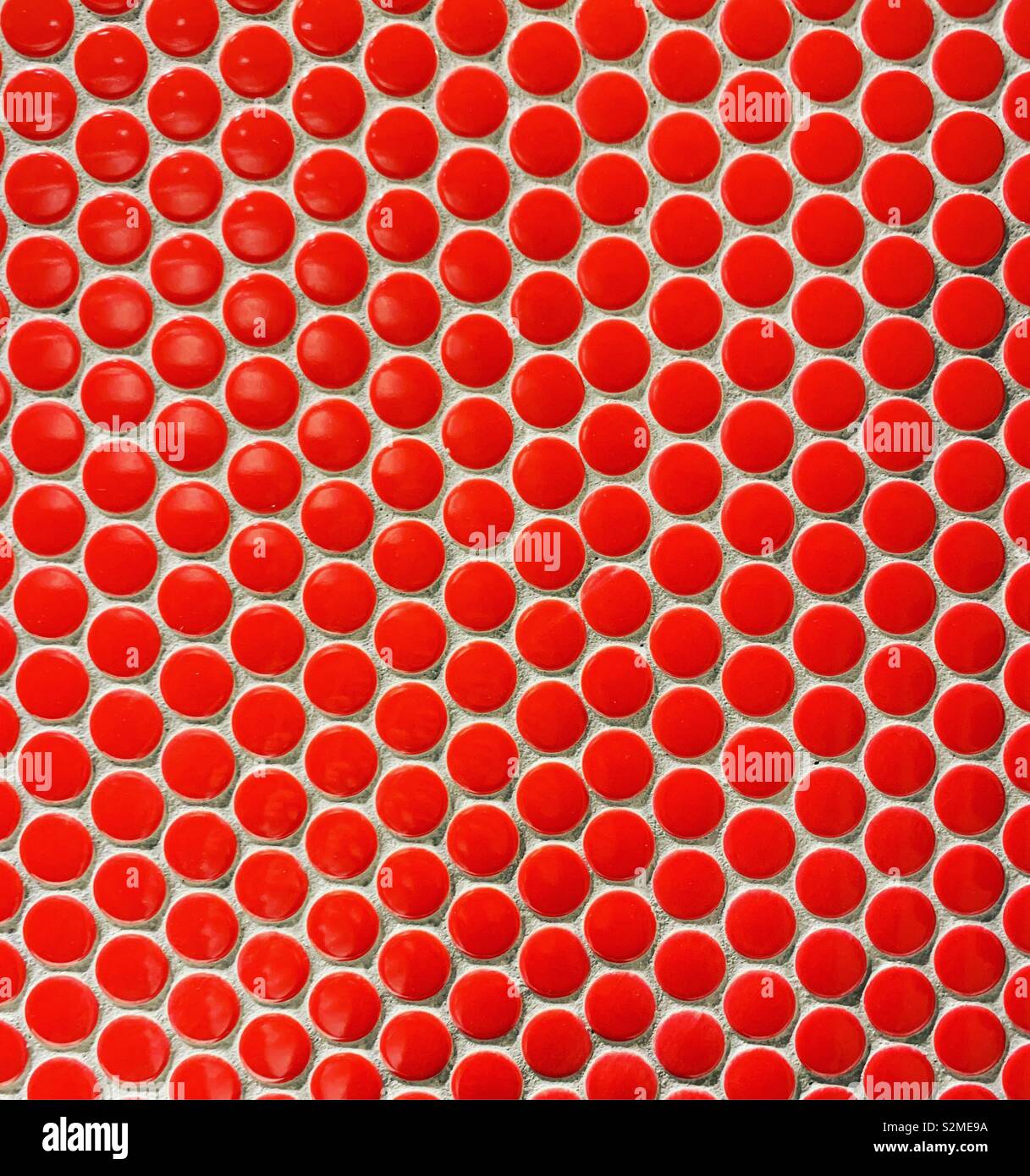 Red circles repeated in a tile pattern - Smartphone Captured Stock Image
