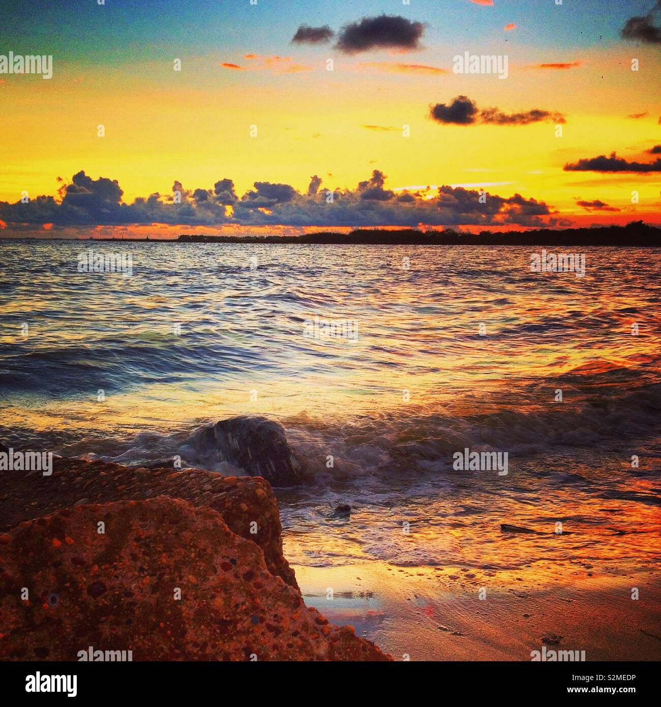 The sun sets over the water in Bayou La Batre, Alabama. Stock Photo