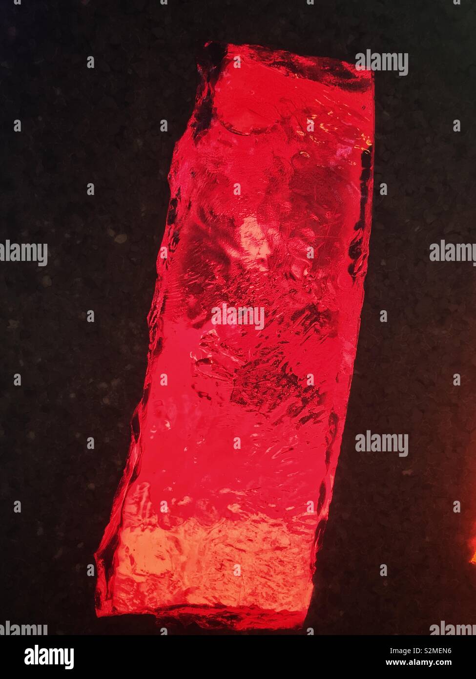 Decorative bright red colored stained textured translucent glass with a random abstract pattern. - Smartphone Captured Stock Image