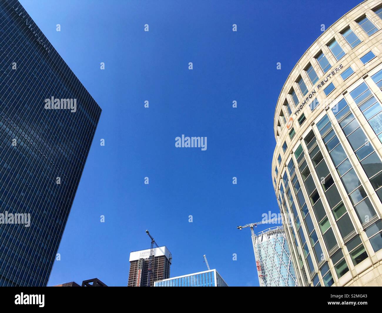 JP Morgan building on the left and the Thomson Reuter’s building on the right on Canary Wharf in London, England on April 30 2019 - Smartphone Captured Stock Image