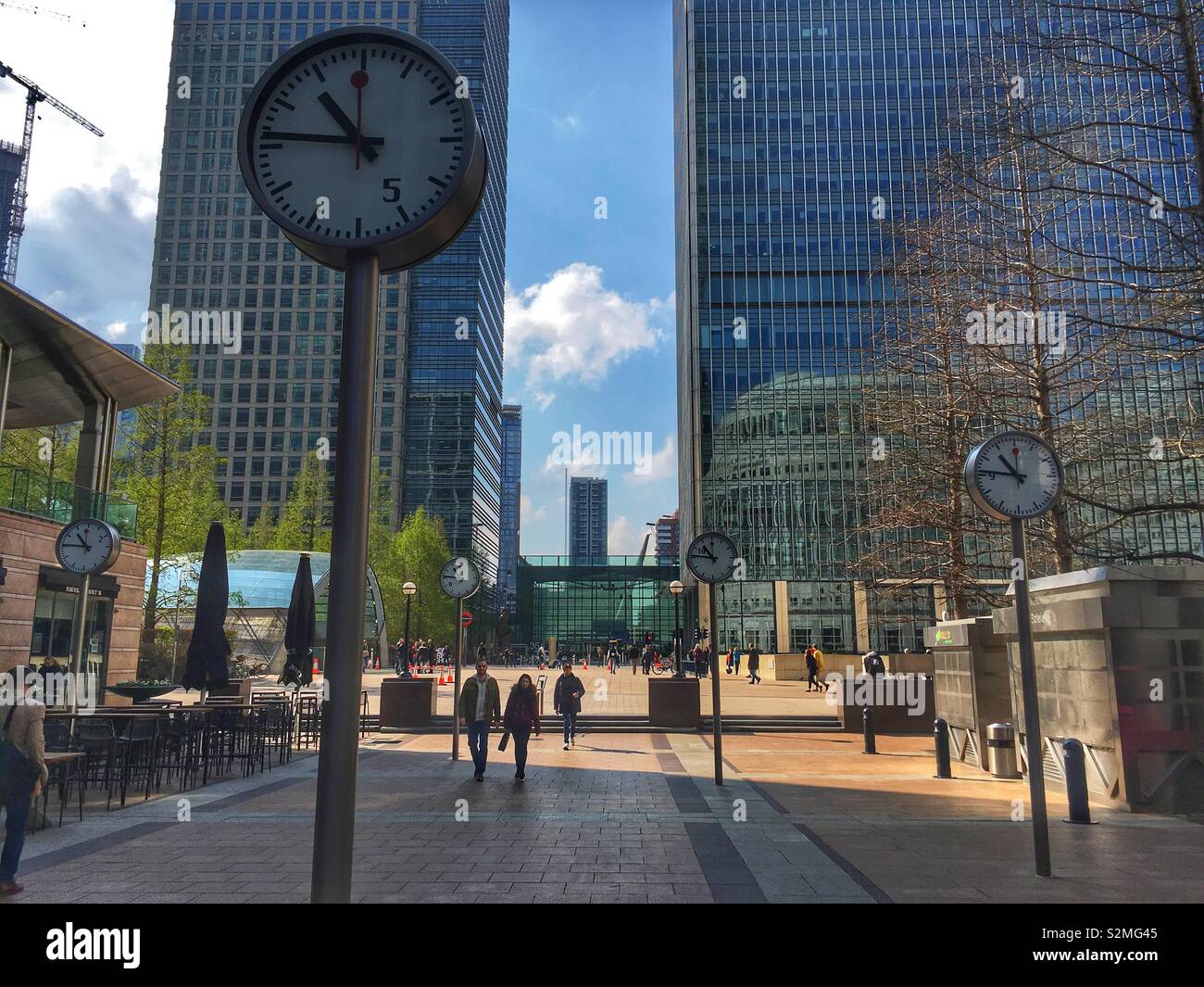 6 Public clocks at the Reuter’s plaza in Canary Wharf in London, England in April 2019 - Smartphone Captured Stock Image