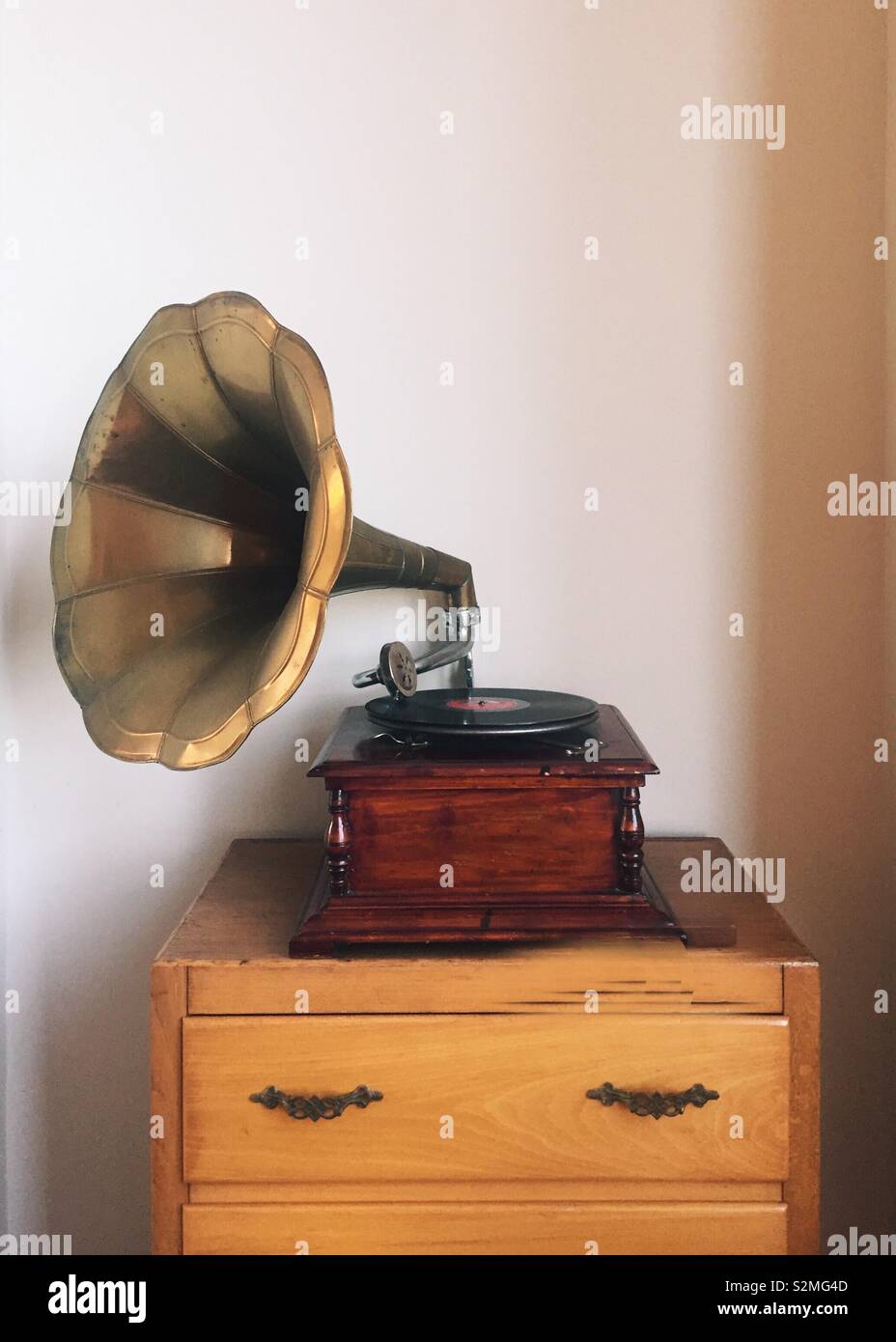 An old gramaphone on top of a chest of drawers Stock Photo