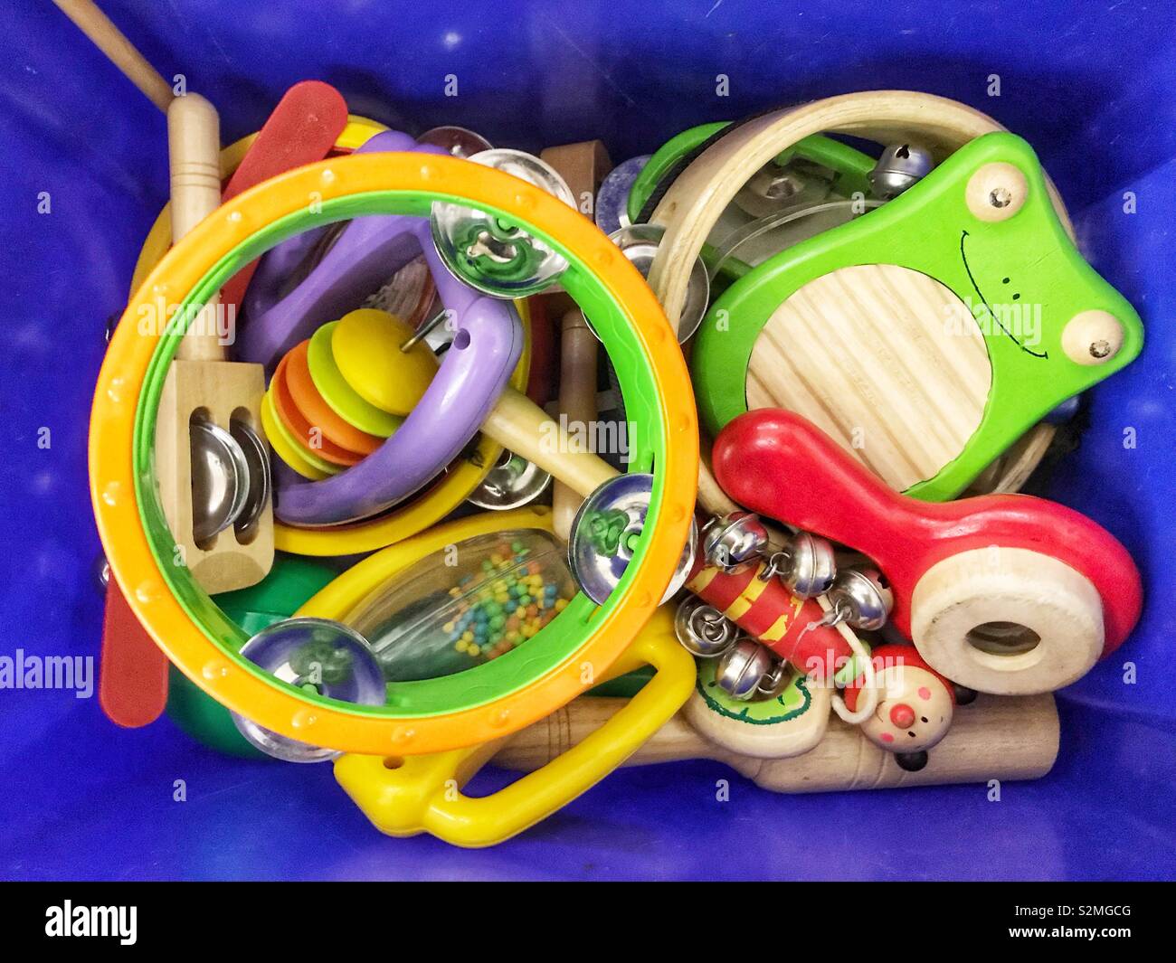 A plastic box filled with children’s musical instruments. - Smartphone Captured Stock Image