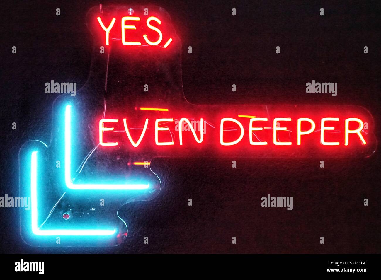 Modern, young, stylish, urban neon sign. Found in asia, saying: yes, even deeper Stock Photo